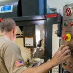 A man standing in front of a machine at a Florida company